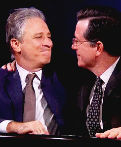 Jon Stewart kissing Stephen Colbert gif